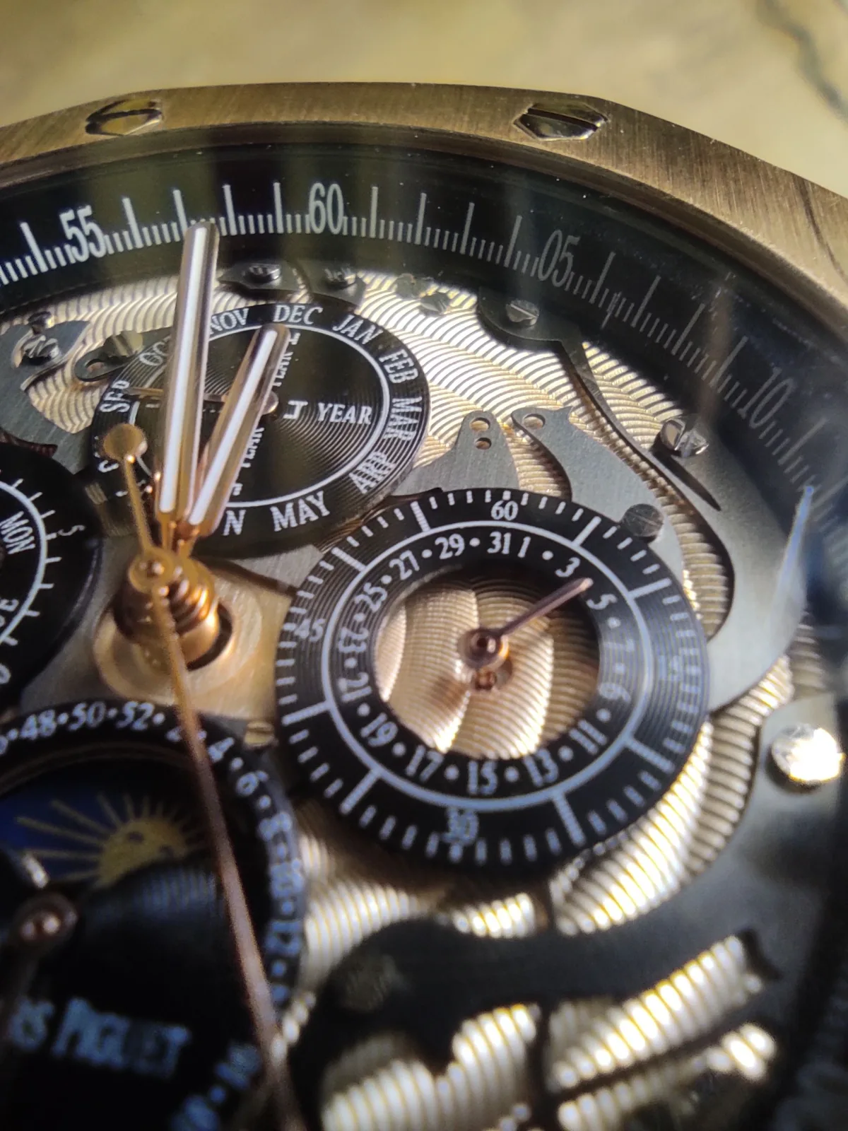 Close-up of a perpetual calendar dial with blued hands